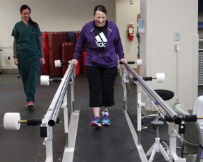 patient on treadmill working with physical therapist